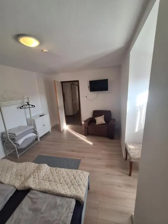 „6” apartman szobája kanapéval és ággyal